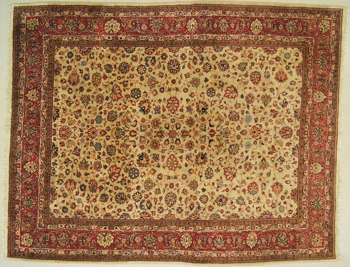 Oriental rug with ivory field, red border, and floral motifs