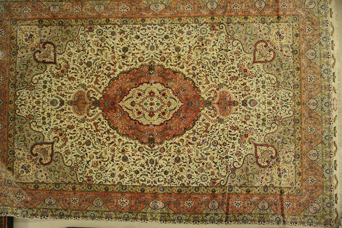 Ornamental patterned rug in cream, red, and brown hues