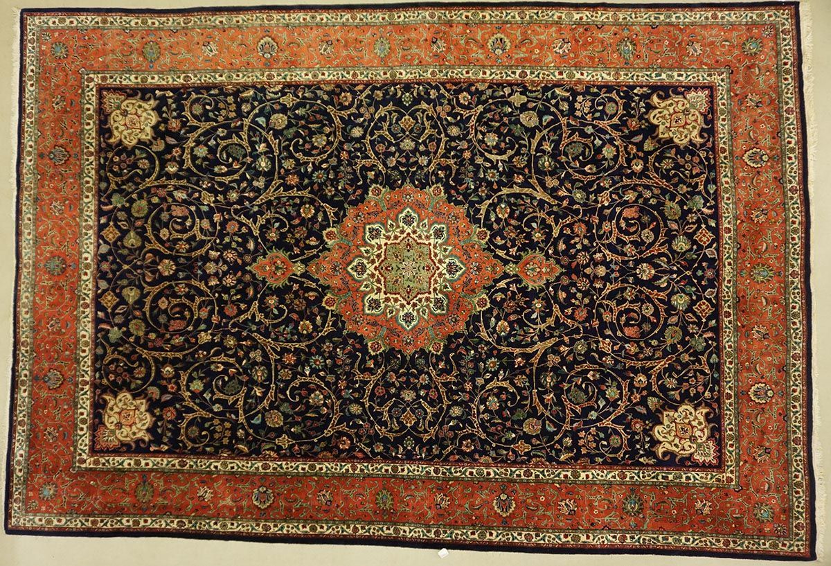 Ornate, dark blue Persian rug with a burnt orange border and central medallion, floral patterns