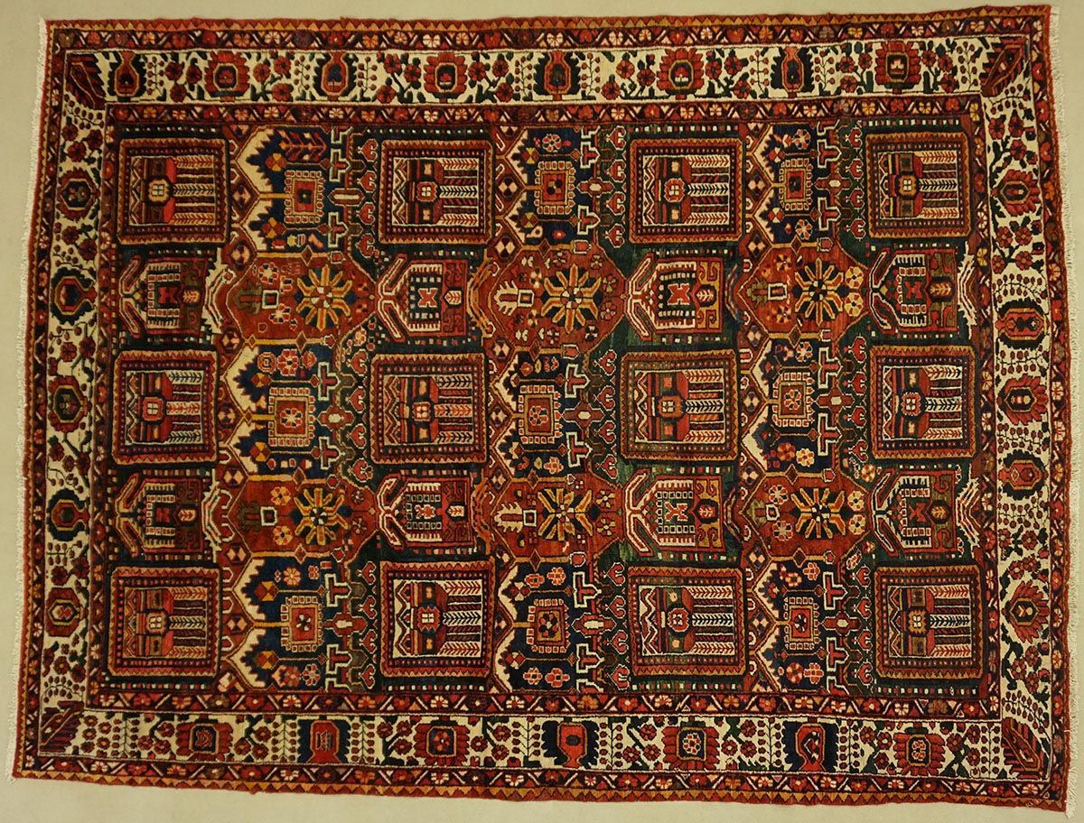 Red, black, and white Oriental rug with geometric patterns and central medallion design