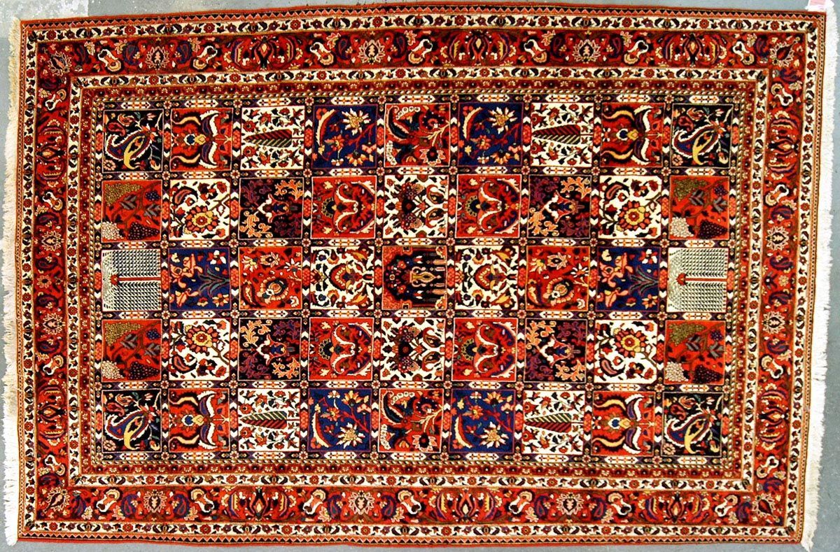 Oriental rug with repeating floral pattern in red, blue, and white squares