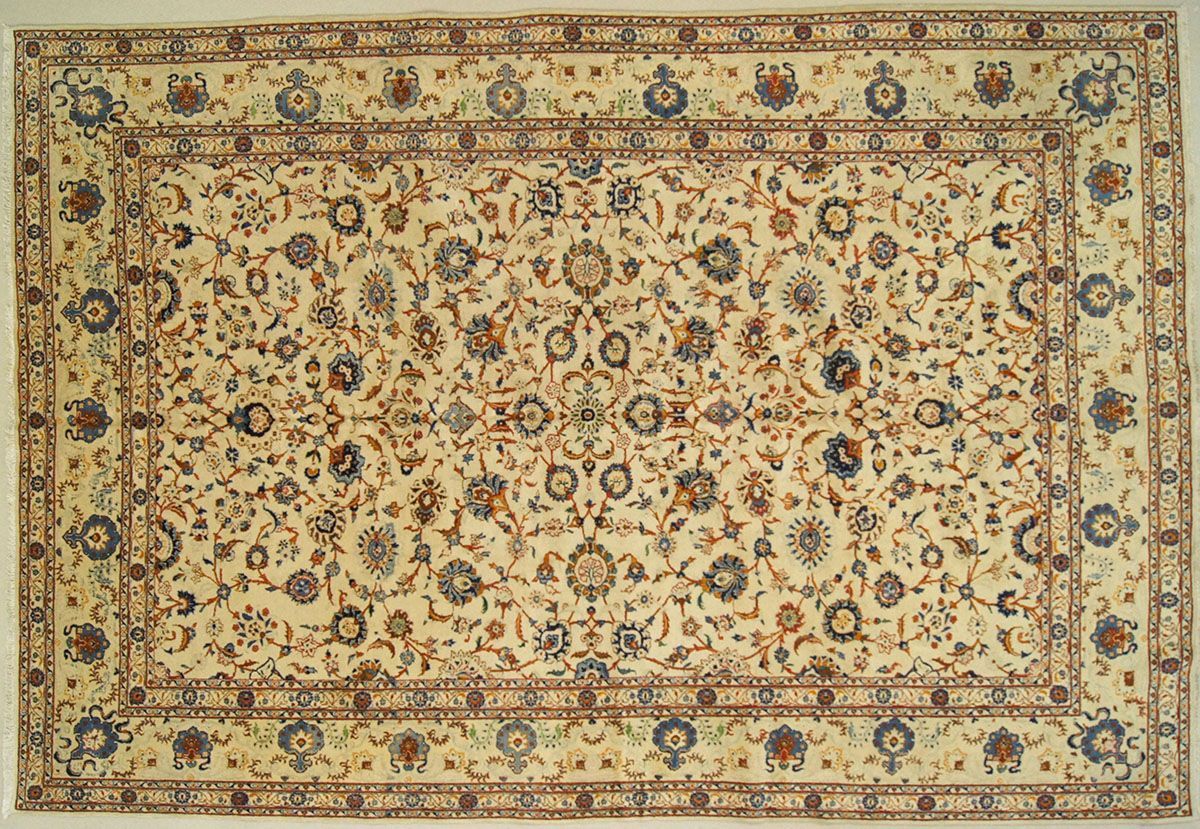 Cream-colored rectangular rug with floral patterns, bordered by a brown and cream design