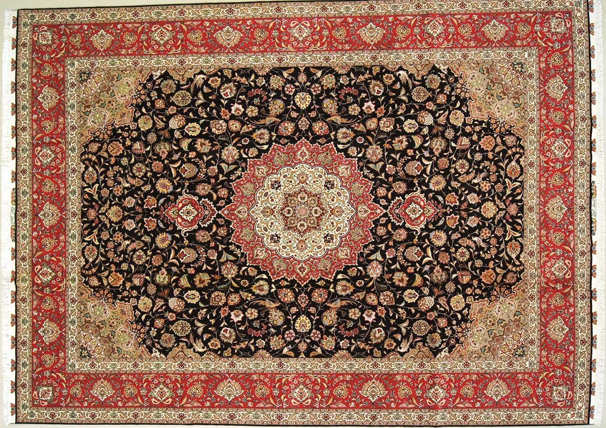 Ornate Persian rug with a black floral center, red border, and beige accents