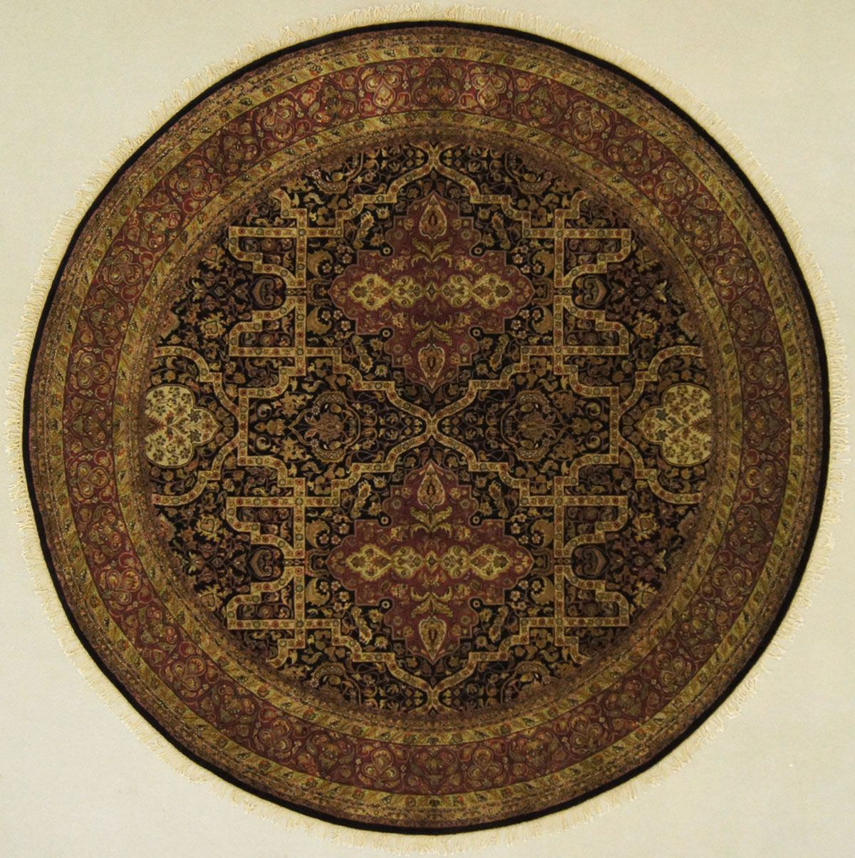 Circular ornate rug with dark red, gold, and black patterns