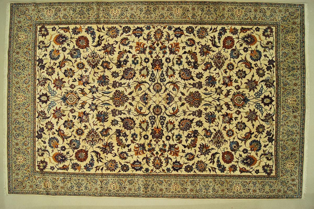 Floral patterned rug with cream background, dark and orange flowers, and patterned border