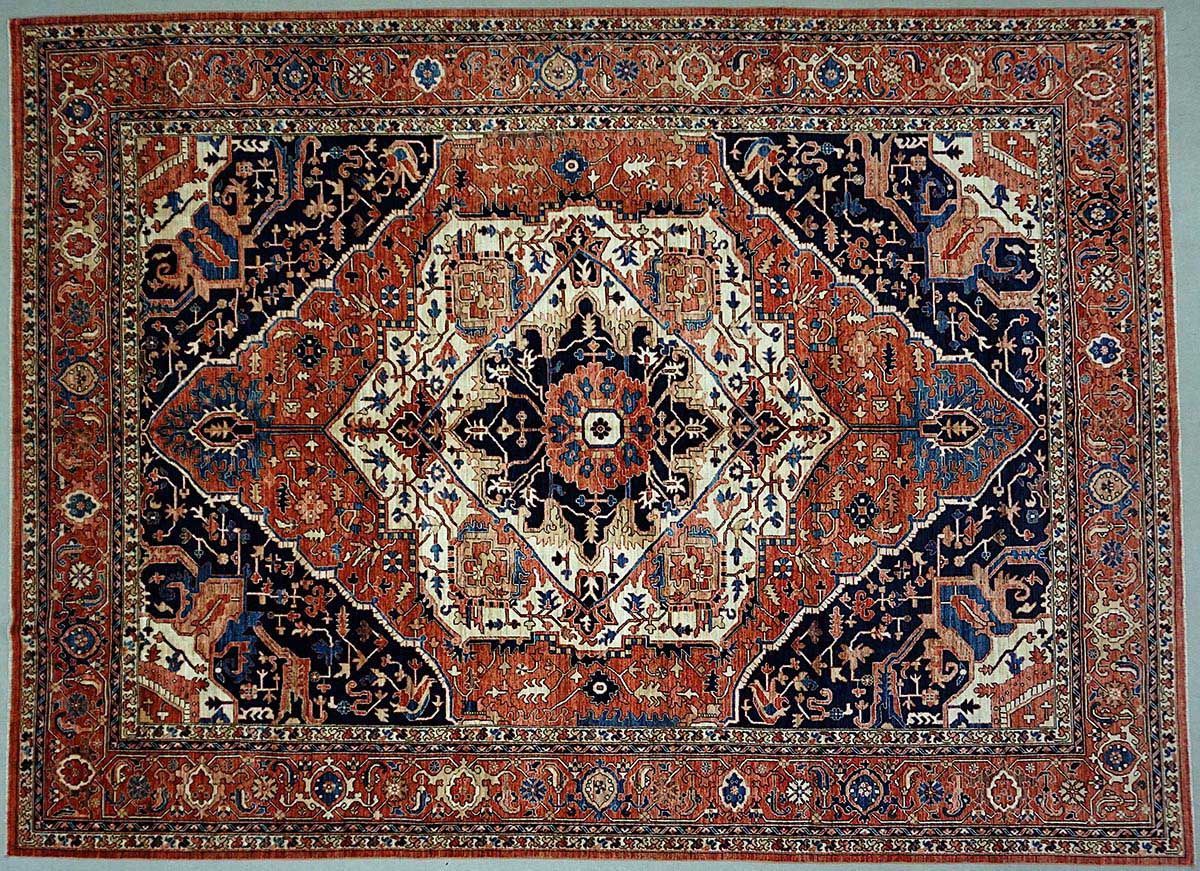 Oriental rug with central medallion design in shades of rust, navy, and ivory