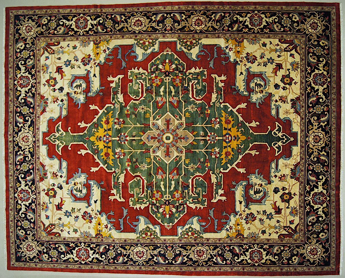 Ornamental rug with red, green, and cream central design, black floral border