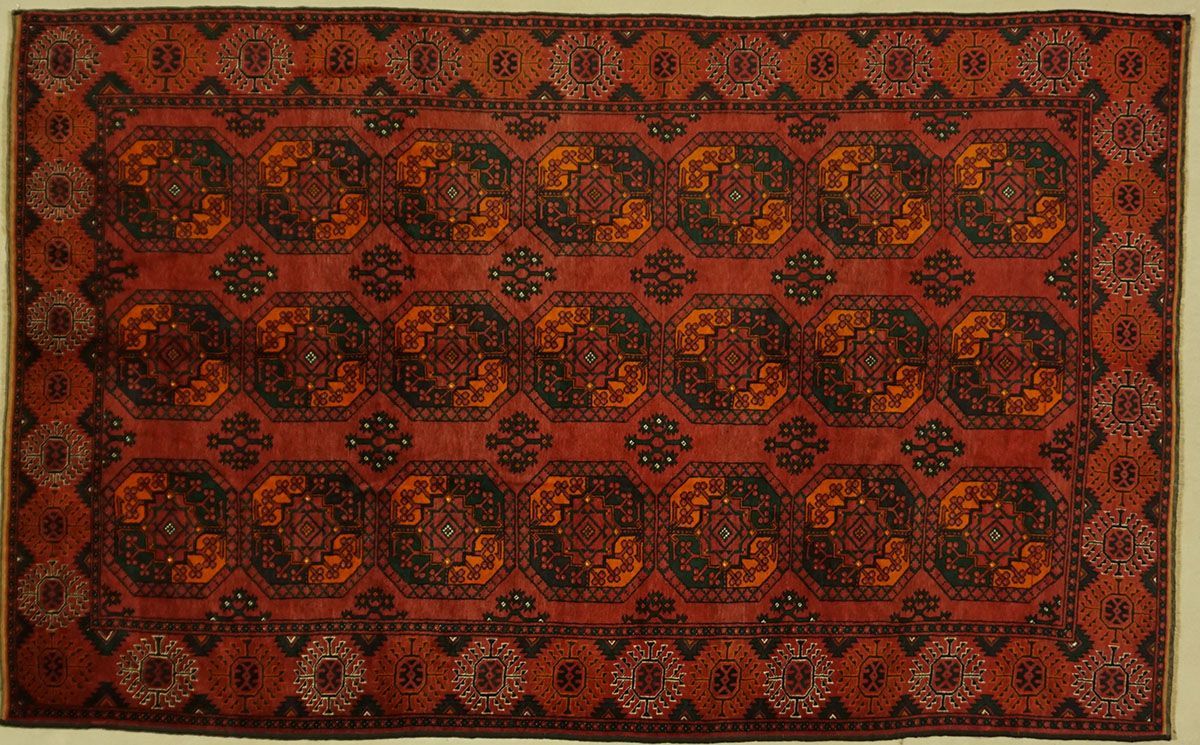 Red and black oriental rug with repeating geometric and floral patterns, and a patterned border