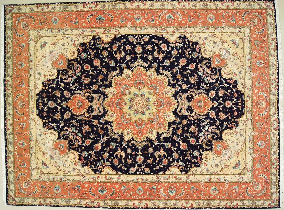 Oriental rug with a central navy design and peach border