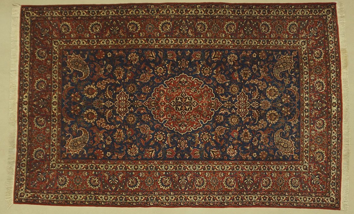 Dark blue and red Oriental rug with detailed floral patterns and a central medallion