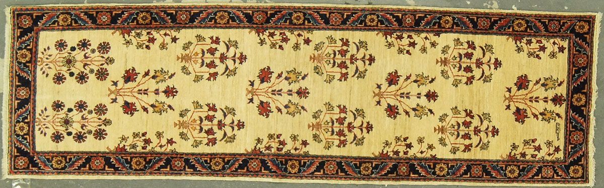 Tan and brown floral runner rug with a patterned border