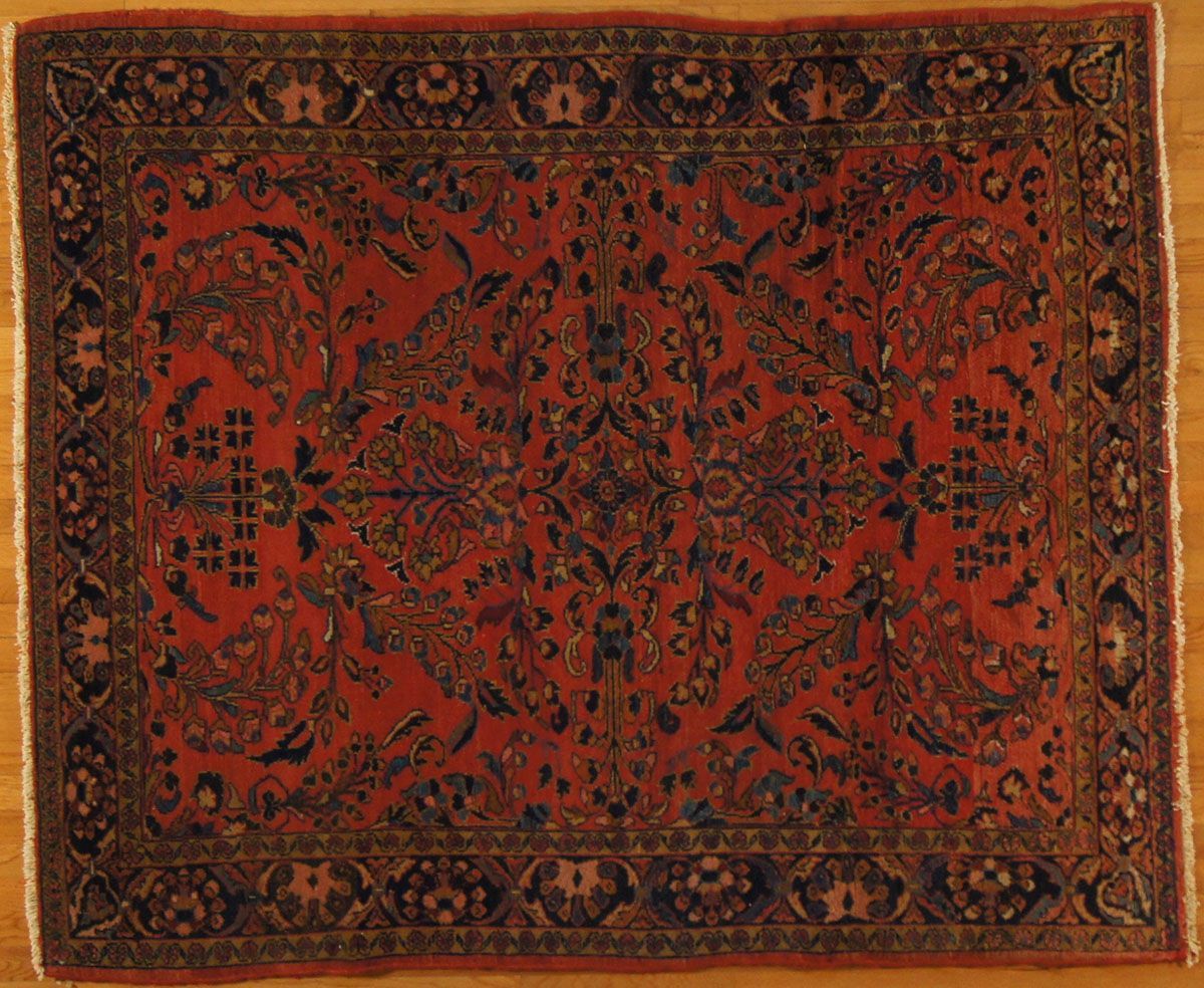 Red and blue patterned Oriental rug on wooden floor