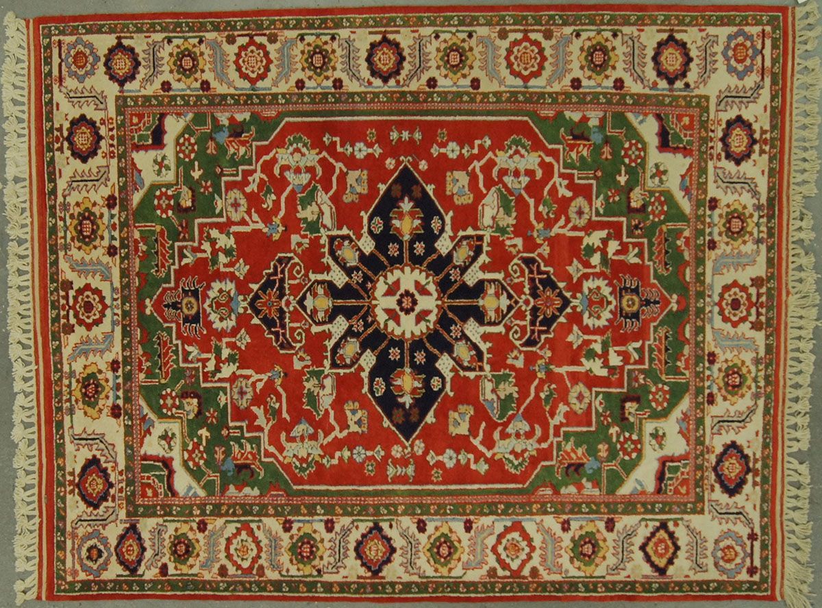 Red, green, and cream-colored Oriental rug with intricate floral and geometric patterns