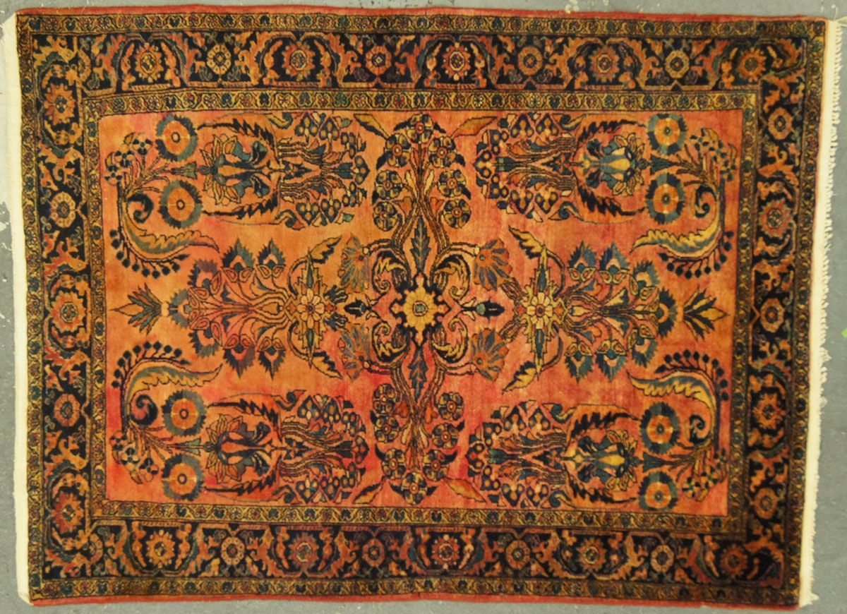 Orange and black Oriental rug with floral and paisley designs