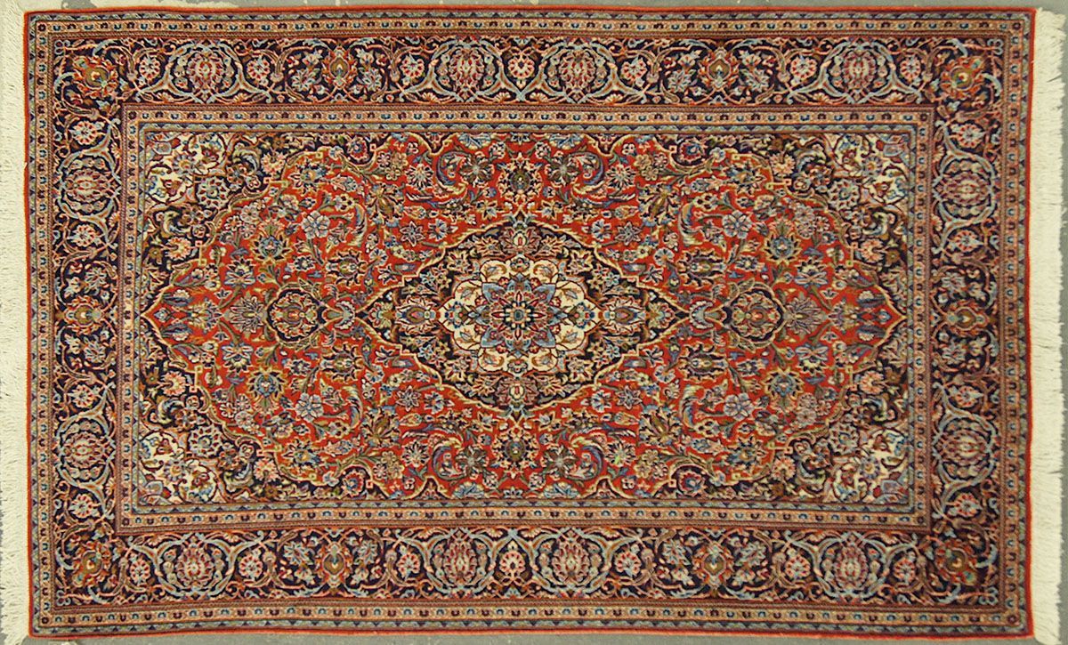Red, ornate Oriental rug with floral and geometric patterns