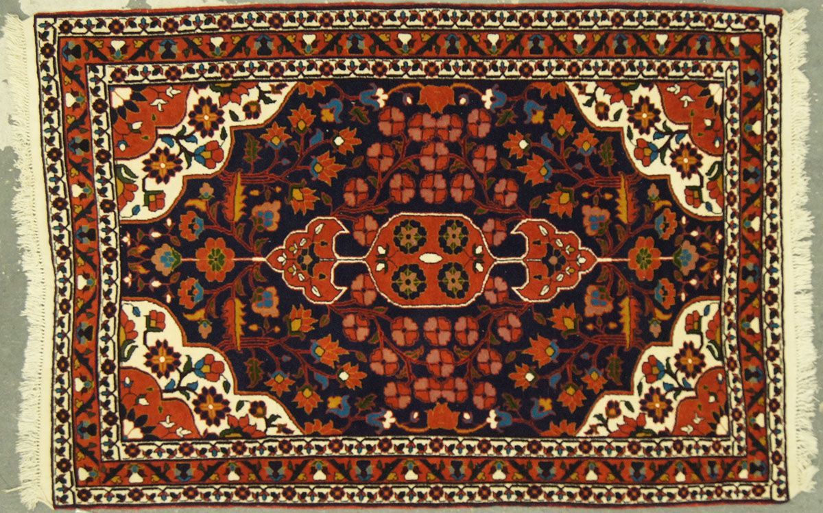 Rectangular Persian rug with red, blue, orange, and white floral and geometric patterns