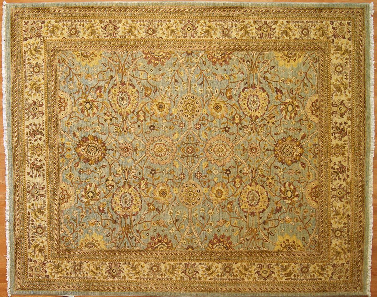 Blue and gold oriental rug with intricate floral pattern and border