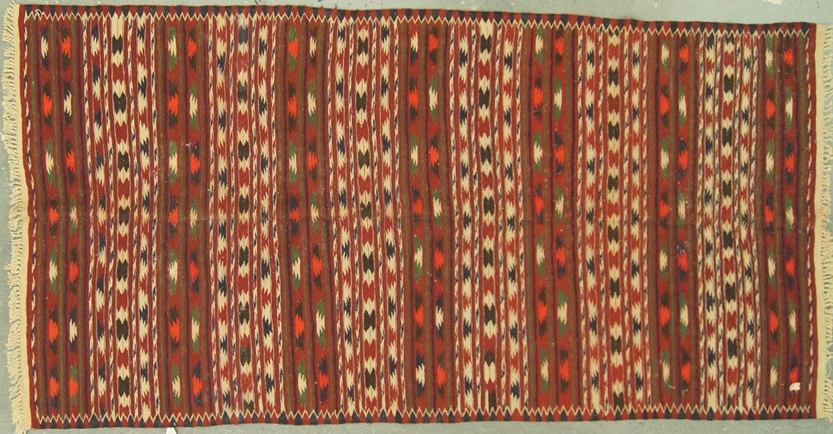 Brown and white patterned rug with vertical stripes and fringed edges