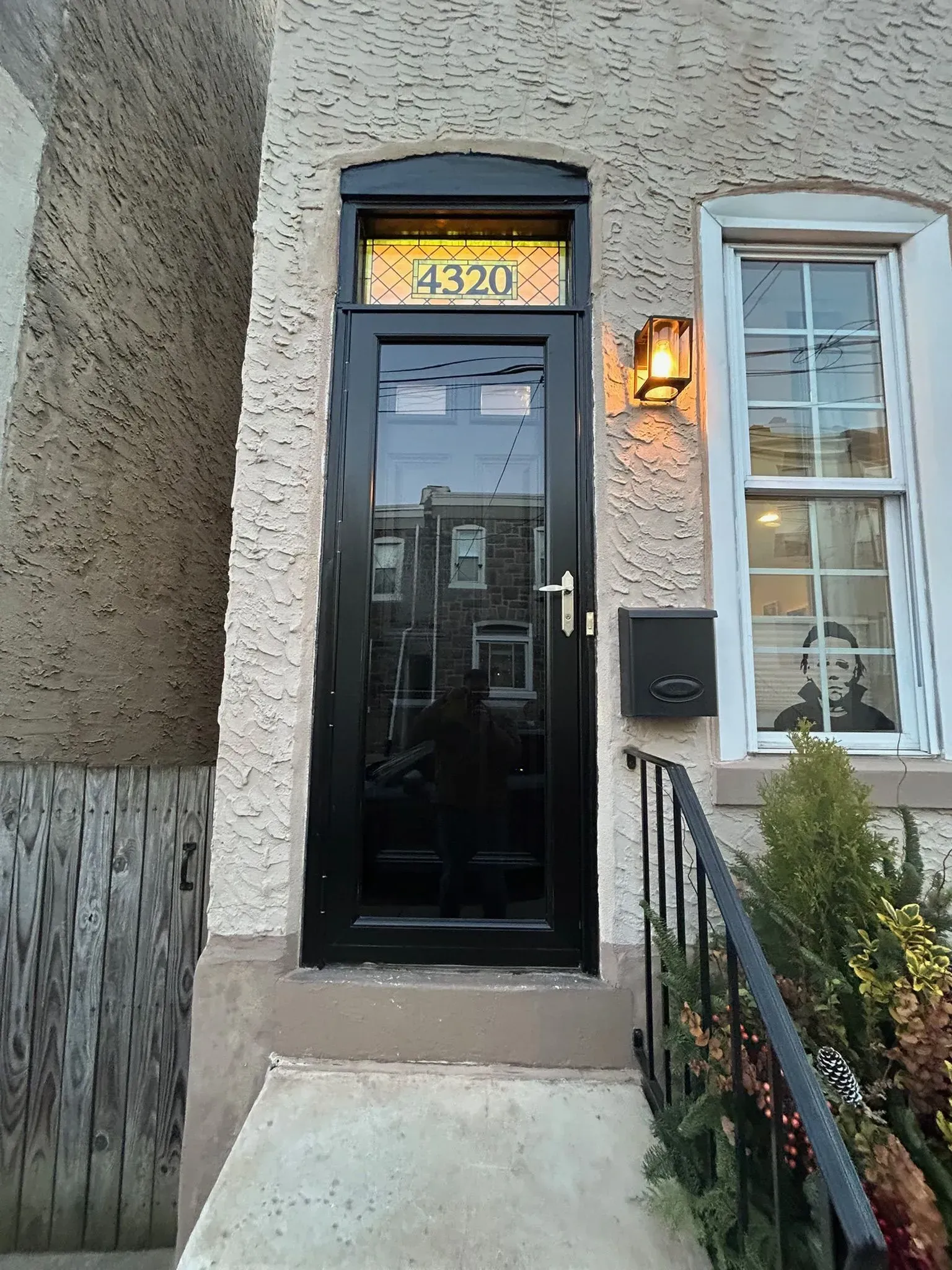 Black front door with address 