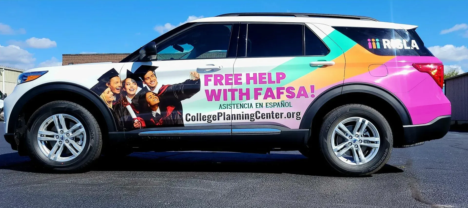 White SUV with colorful graphics, text 