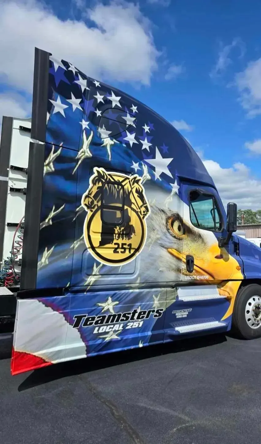Semi-truck cab with American flag design and Teamsters logo.
