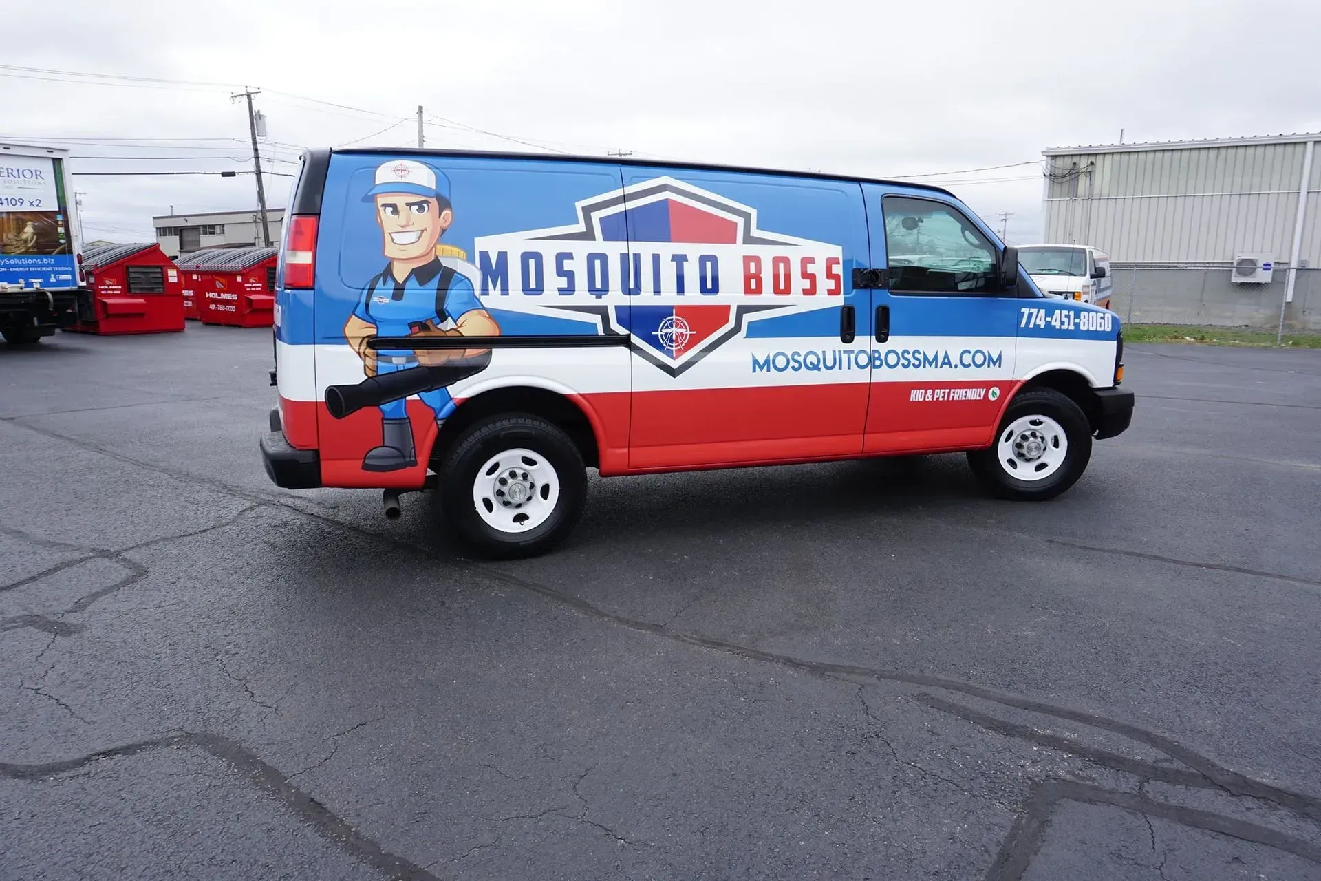Mosquito Boss van with logo of cartoon man holding sprayer; blue, white, and red color scheme.