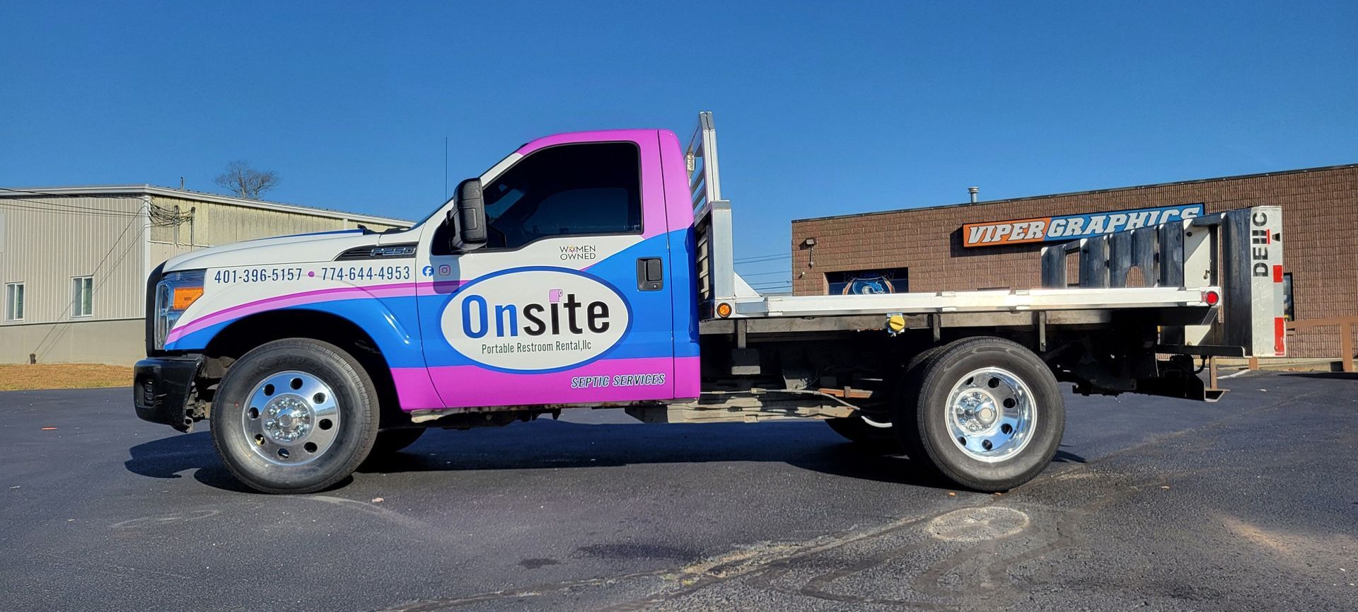 A white and pink work truck with the word