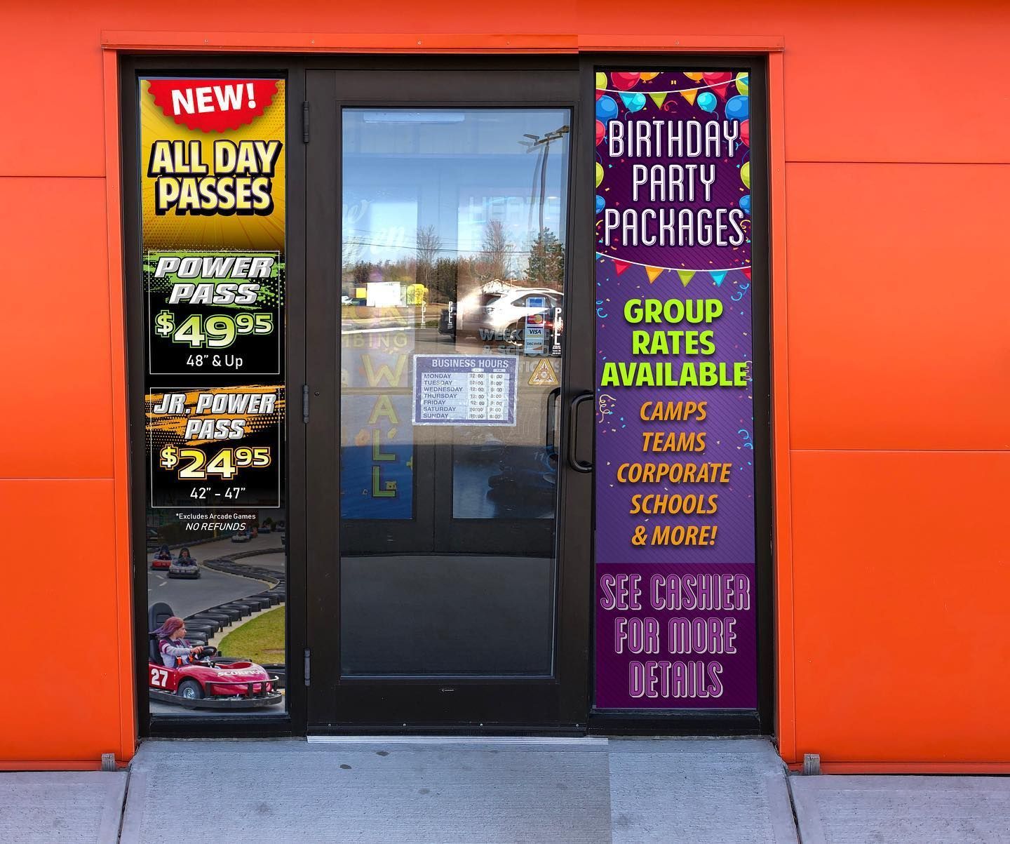An orange building entrance with signage for