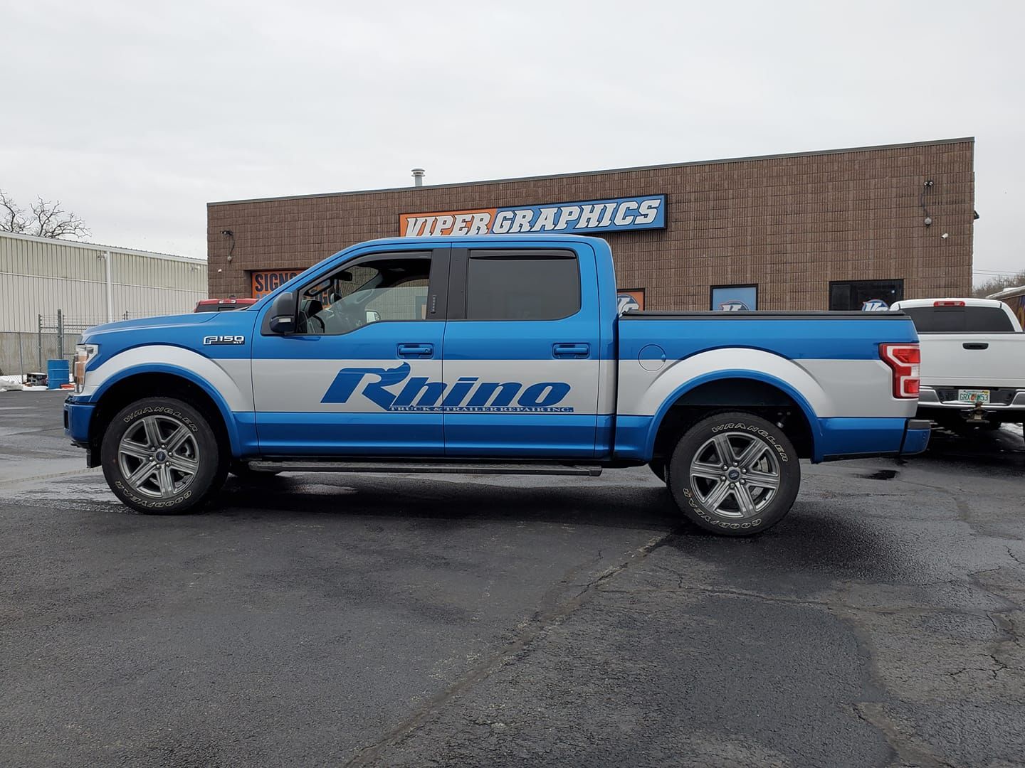 Blue truck with silver accents, the logo