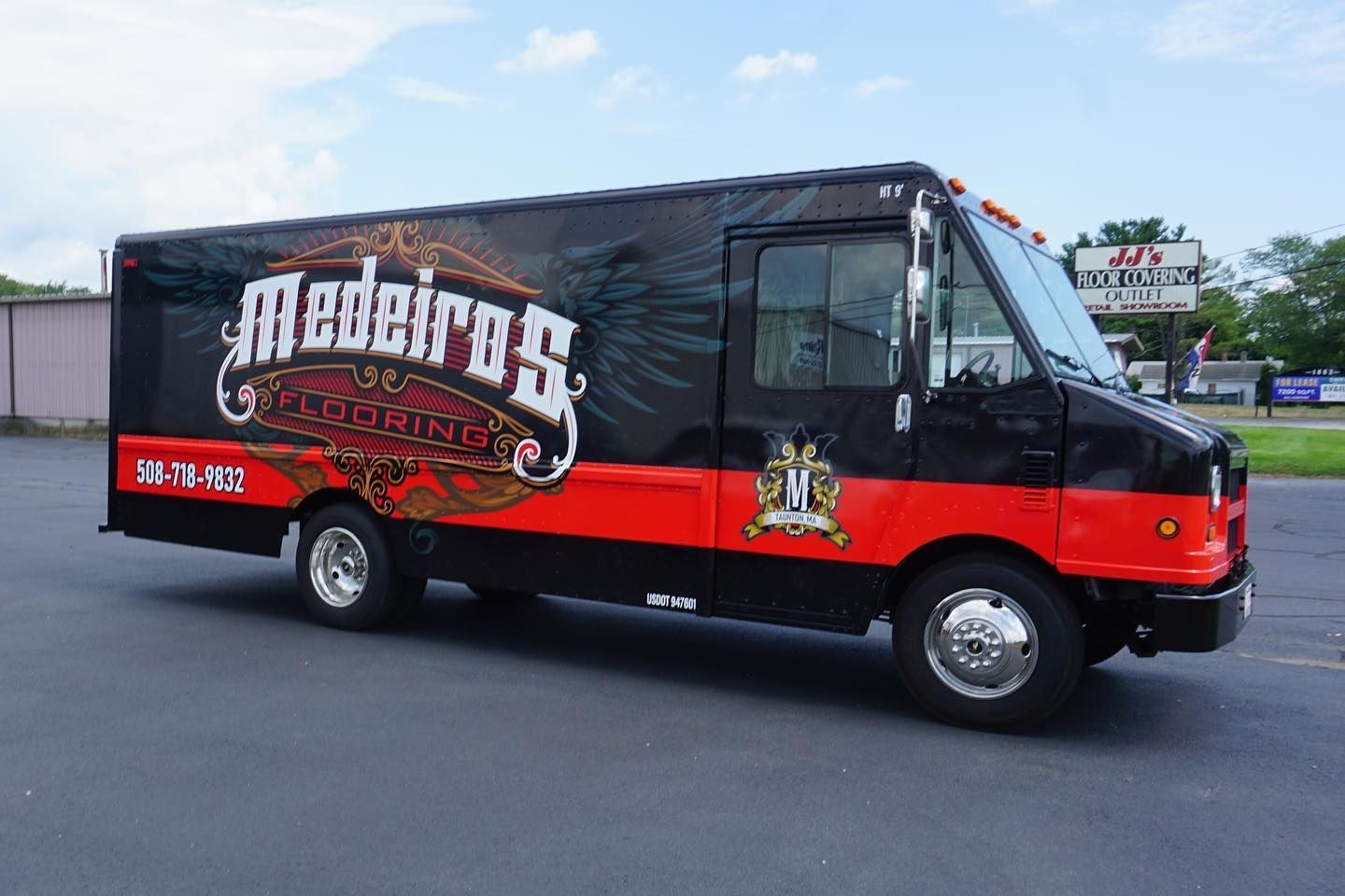 Food truck, Medeiros BBQ, black and red exterior, parked on asphalt.