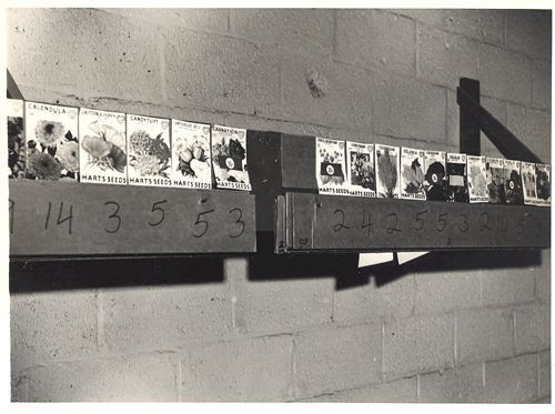 A black and white photo of a shelf with numbers on it