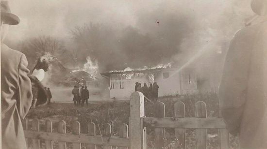 A black and white photo of a fire in a house.