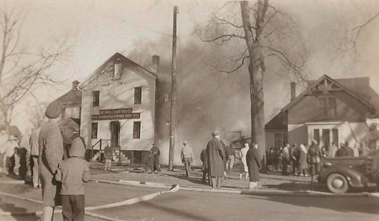 A black and white photo of a fire in a small town.