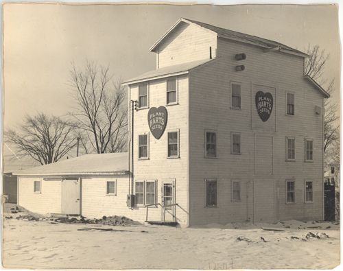A black and white photo of a building with hearts on the side