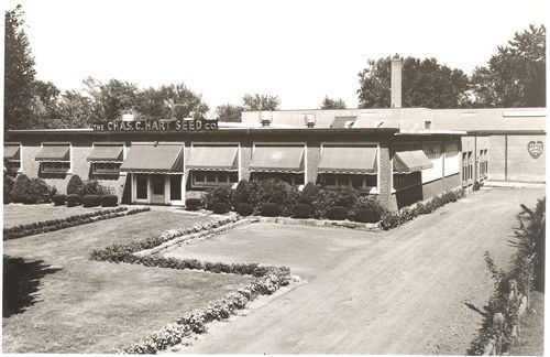 A black and white photo of a building that says chase hart silos