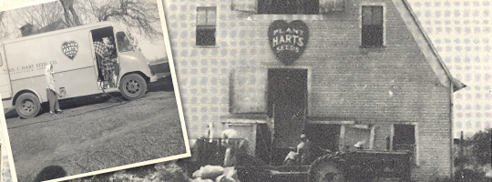 A black and white photo of a van parked in front of a building.