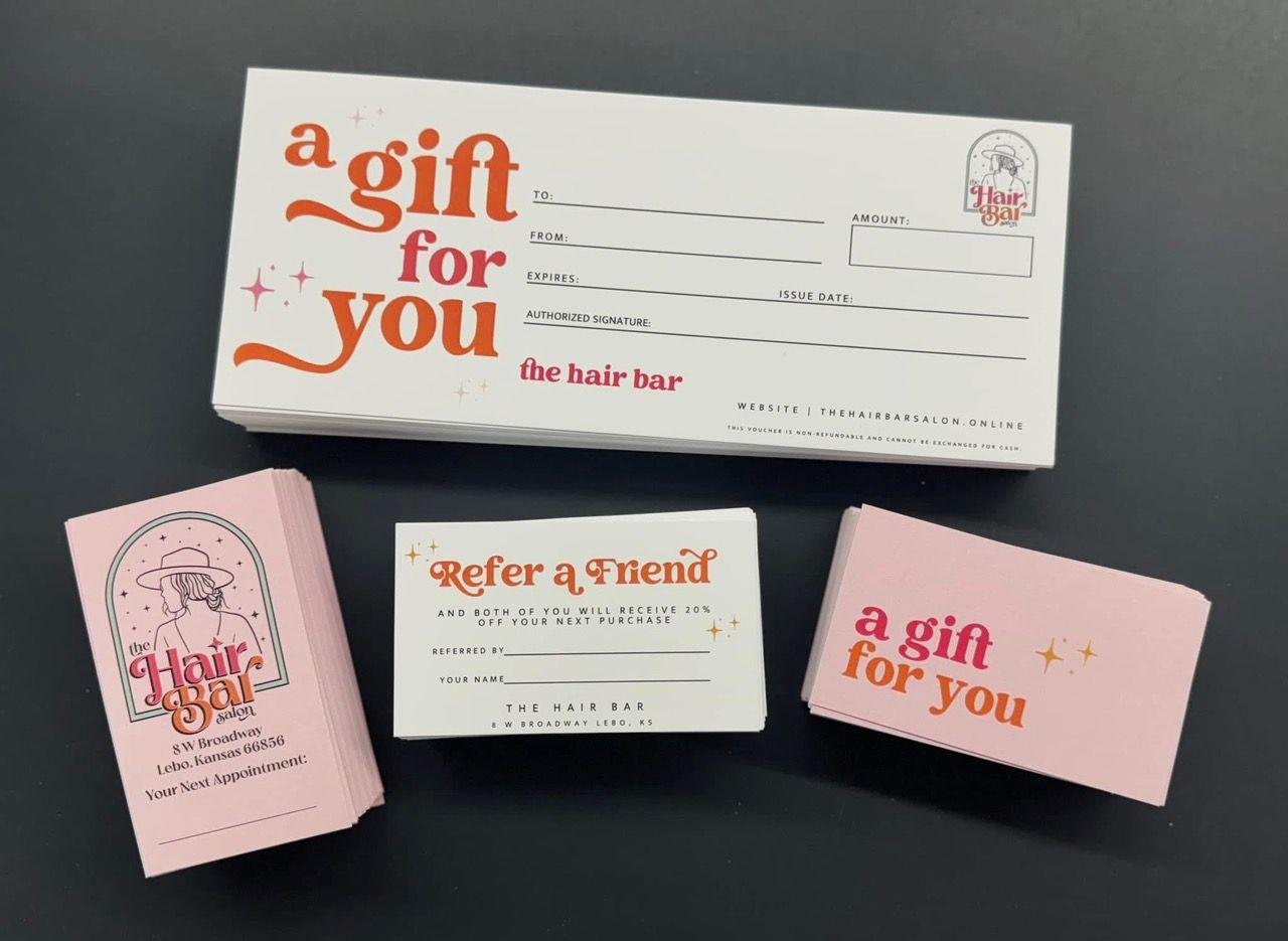 Gift cards and referral cards for 'Hair Up!' salon in various shades of pink and white.