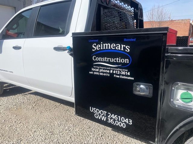 White and black work truck withSeimears Construction logo.