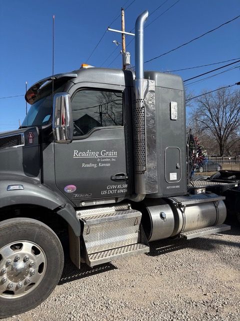 Gray semi-truck with Readley Grain on the side, parked outside on a sunny day.