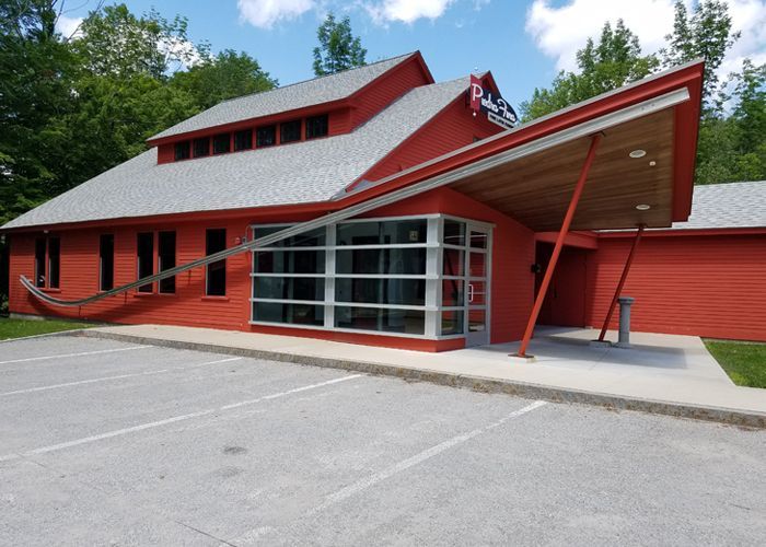 A large red building with a canopy over the entrance