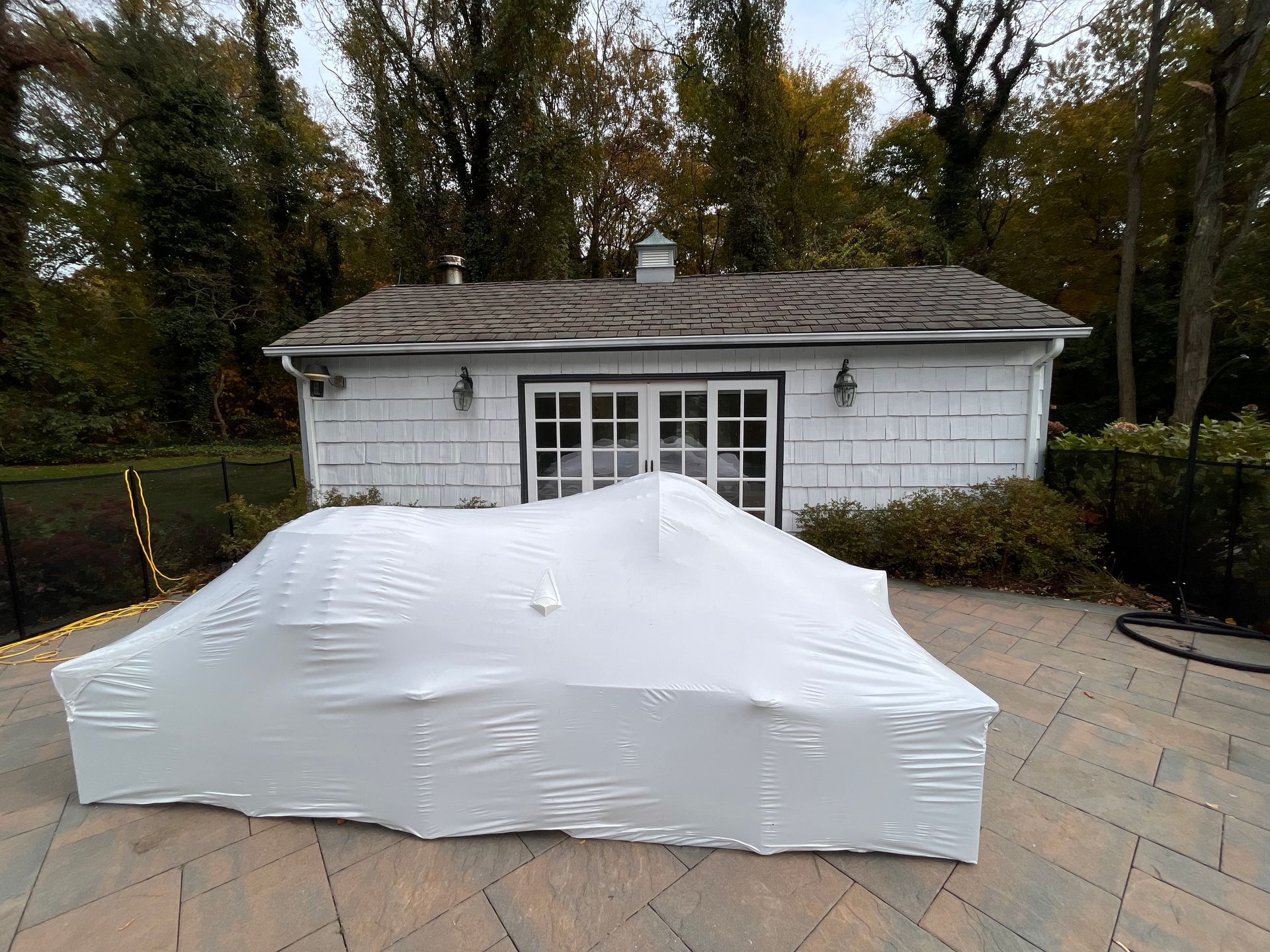 A white house is covered in white plastic wrap