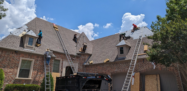 Workers doing roofing services 