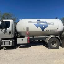 White propane truck with a Texas star logo on a sunny day.