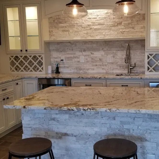 Kitchen with island, granite countertops, stone backsplash, overhead lights, and wine racks