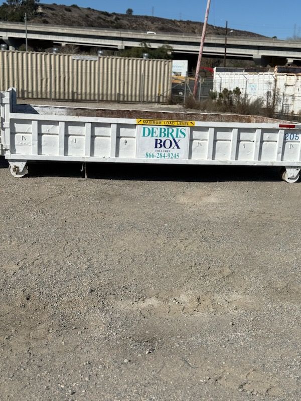 A dumpster with a sign that says debris box