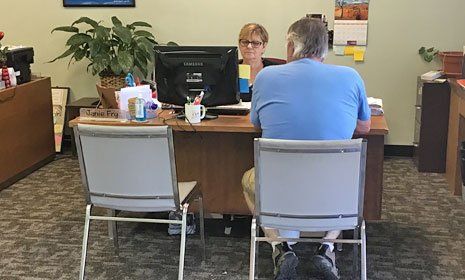 Man consulting an insurance agent in office