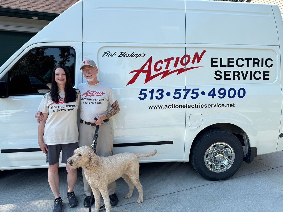 White Action Electric Service van parked on gravel with a ladder rack and company phone number on the side