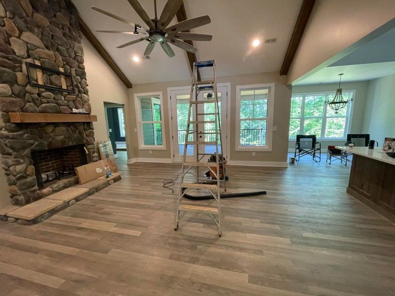 A ladder is sitting in a living room next to a fireplace.