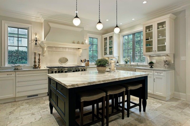 A large kitchen with a large island in the middle.