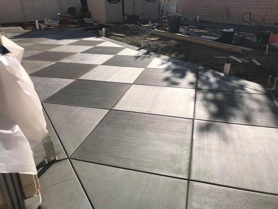 Black-and-white checkered floor tiles laid outdoors in a patio or courtyard area